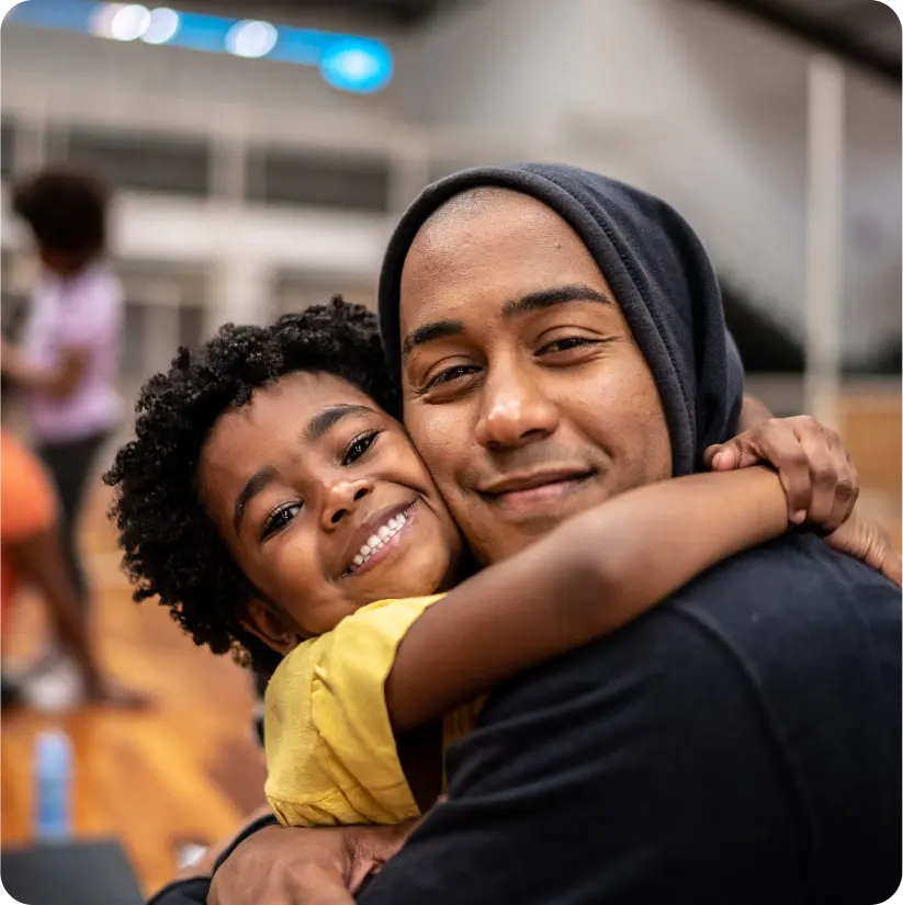 A parent hugging their child.